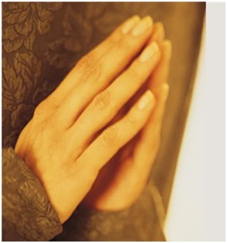 St. John's United Church | A woman's hands are clasped in prayer.