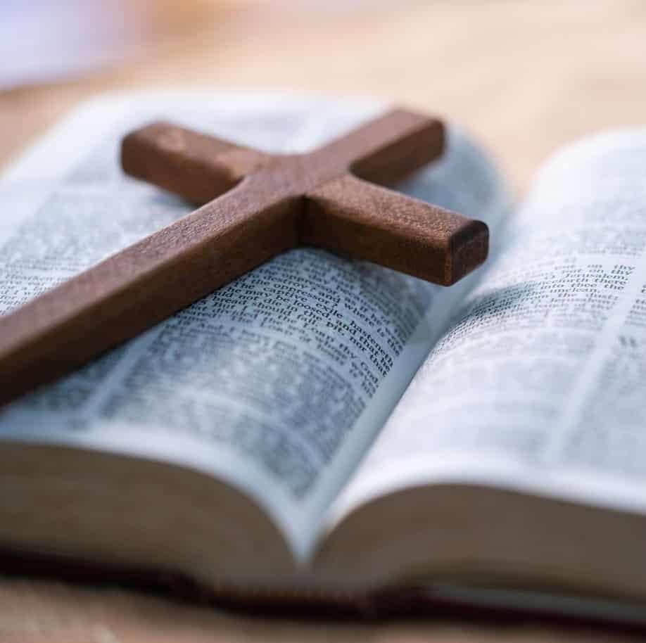 St. John's United Church | A wooden cross sits on top of an open bible.