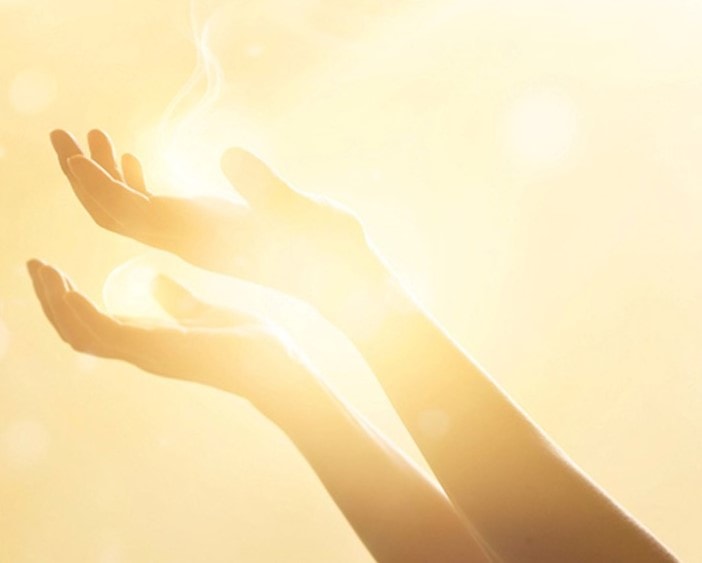 St. John's United Church | A woman's hands reaching out to the sun.