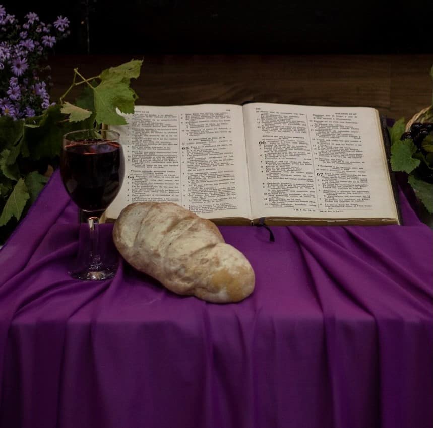 St. John's United Church | A bible, bread and wine on a purple cloth.