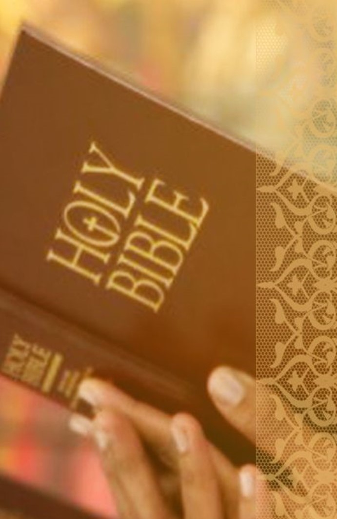 St. John's United Church | A person holding a brown Holy Bible with gold lettering on the cover.