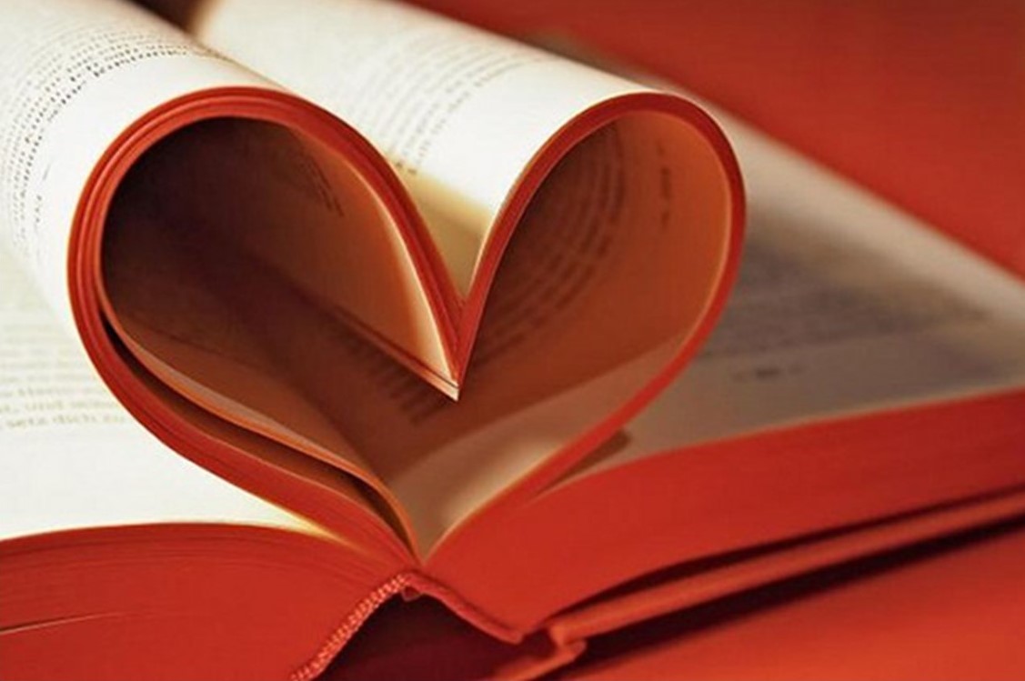 St. John's United Church | Open book pages curved into a heart shape against an orange background.