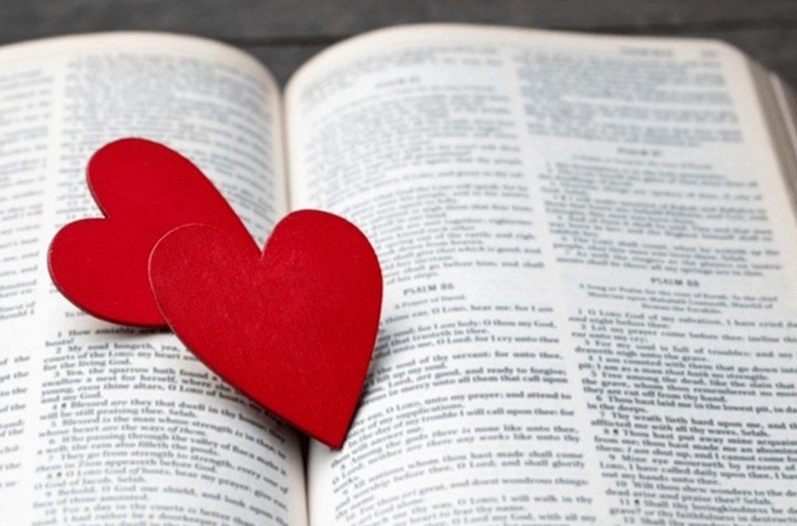 St. John's United Church | Open book with two red heart-shaped cutouts placed on the pages.